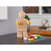 LEGO Originals 853967 Wooden Minifigure displayed on a desk with LEGO bricks
